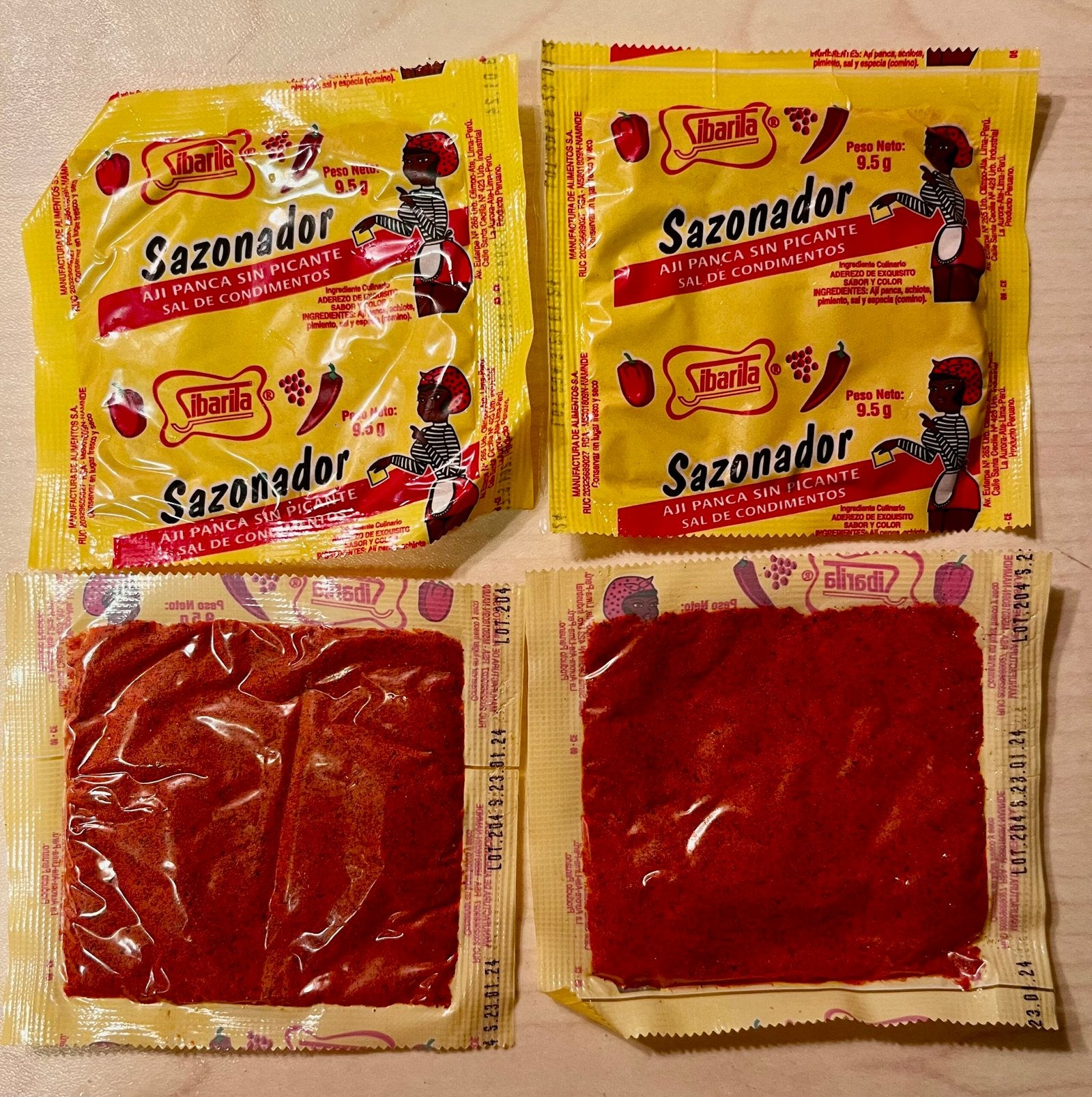 Ají Panca Sibarita seasoning packets with distinctive yellow packaging and red powder, perfect for enhancing Peruvian dishes.